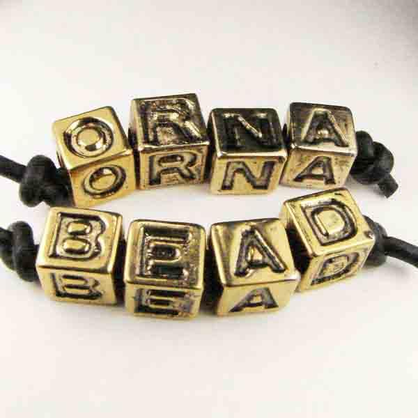 A Antique Gold Plastic Letter Cube Bead